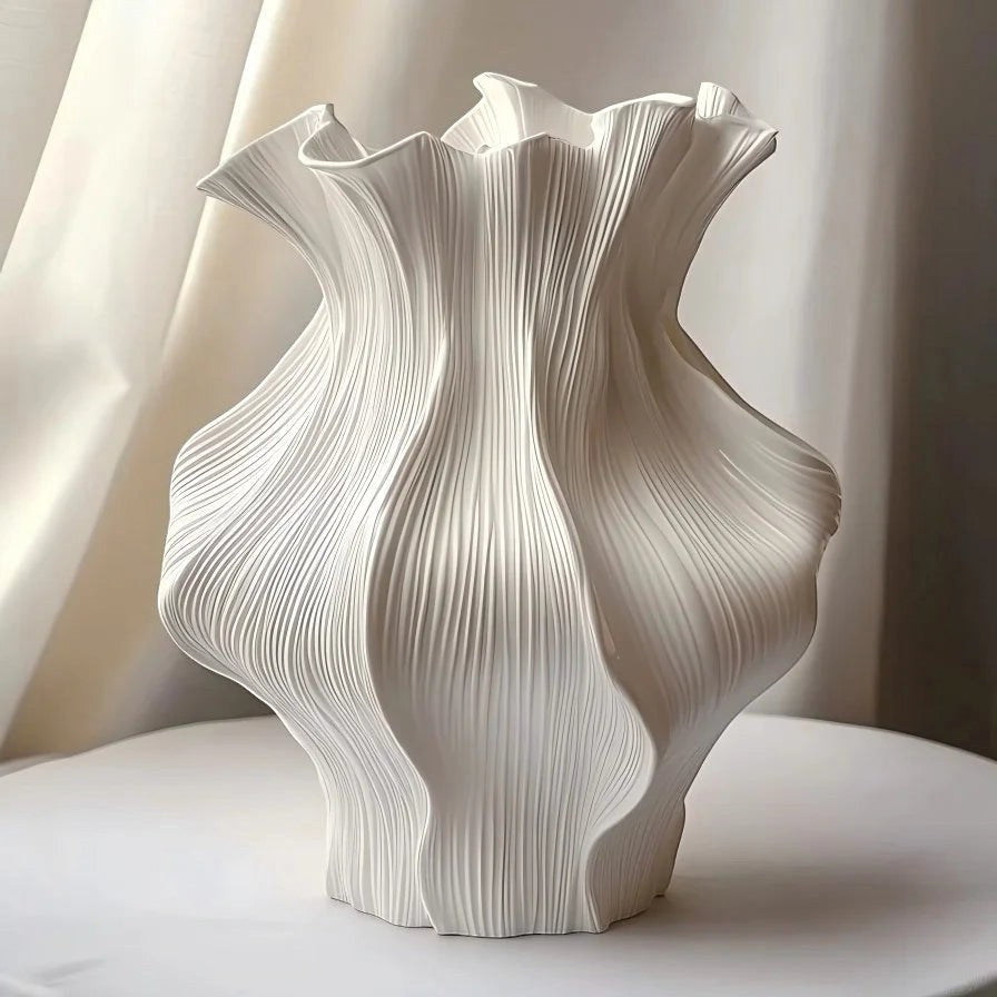 Textured ceramic wave vase with sculptural ripple shape and matte neutral finish