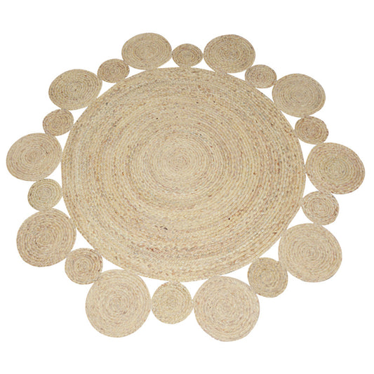Round natural jute rug with woven texture under a modern chair and side table