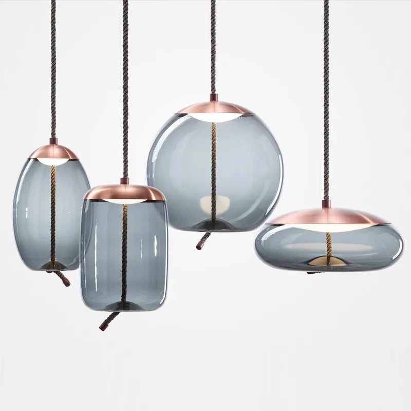 Modern LED Pendant Light — Chandelier for Living & Dining Room featuring four unique smoky glass shades with copper accents and twisted cords, showcasing minimalist pendant lighting.