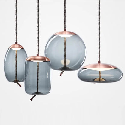Modern LED Pendant Light — Chandelier for Living & Dining Room featuring four unique smoky glass shades with copper accents and twisted cords, showcasing minimalist pendant lighting.