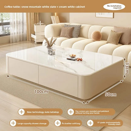 Nordic Clear Designer Coffee Table — Minimalist Living Room Décor featuring a sleek white slate tabletop with rounded edges, integrated storage drawers, and a soft leather finish in a cozy, modern living space.