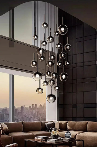 Nordic Stair Chandelier — Living & Dining Room Pendant Ceiling Light with multiple hanging glass spheres illuminating a modern living space featuring large windows and a city skyline view.