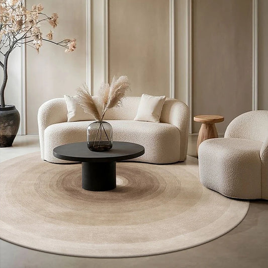 Round gradient area rug with soft blended colors on a light living room floor