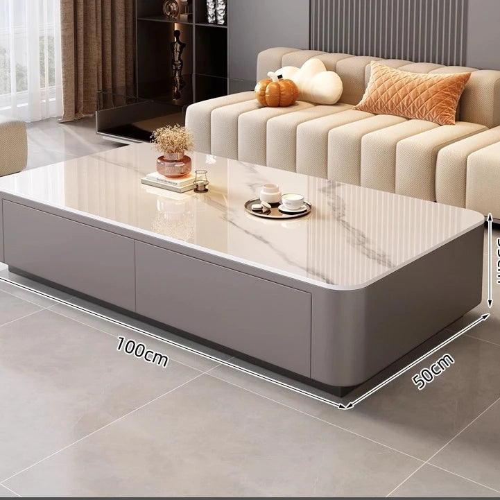 Modern living room featuring a Nordic Clear Designer Coffee Table — Minimalist Living Room Décor with a smooth marble top and sleek grey base next to a beige sofa.