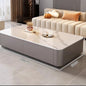 Modern living room featuring a Nordic Clear Designer Coffee Table — Minimalist Living Room Décor with a smooth marble top and sleek grey base next to a beige sofa.