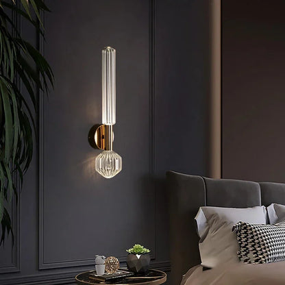 Nordic Luxury Art Glass Chandelier — High-End Pendant Lamp Home Décor mounted on a dark wall above a side table with decorative accents and next to a modern bed with pillows in a stylish bedroom setting.