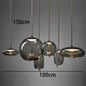 Modern LED Pendant Light — Chandelier for Living & Dining Room featuring six varying smoke-gray glass globes suspended by thin cords, ideal for elegant pendant lighting and luxury home décor.