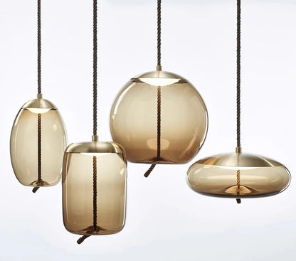 Modern LED Pendant Light — Chandelier for Living & Dining Room featuring four amber-toned glass pendants with bronze fittings, offering a stylish, minimalist statement lighting for contemporary spaces.