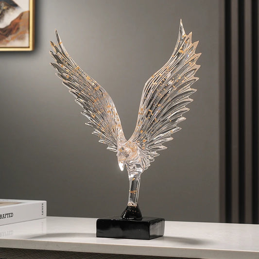 Gold angel wing resin sculpture with black base and sweeping feather detail