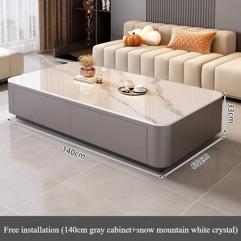 Modern living room featuring a Nordic Clear Designer Coffee Table — Minimalist Living Room Décor with a gray base and glossy white crystal top, paired with a cream sofa and warm-toned cushions.