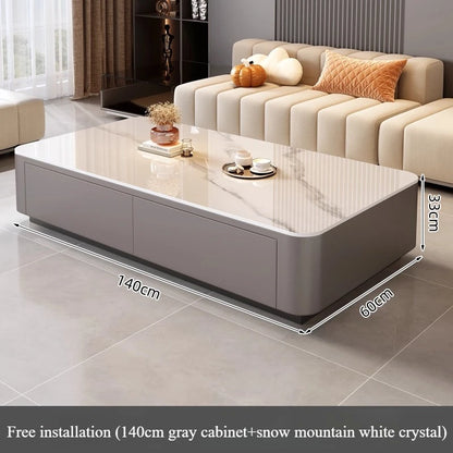 Modern living room featuring a Nordic Clear Designer Coffee Table — Minimalist Living Room Décor with a gray base and glossy white crystal top, paired with a cream sofa and warm-toned cushions.