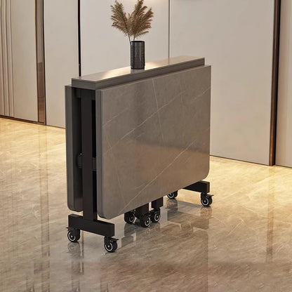 Dark extendable dining table with sleek rectangular top and modern sculptural base