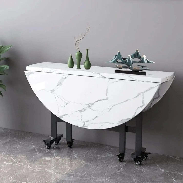 Round foldable dining table with rolling casters and foldable top, seats six, minimalist design