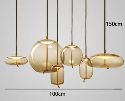 Modern LED Pendant Light — Chandelier for Living & Dining Room featuring six amber glass pendant lights with organic shapes and brass accents, perfect for luxury home décor.