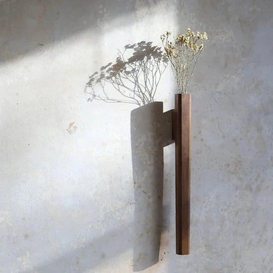Japanese hanging wall vase handcrafted from natural wood with a single dried stem display