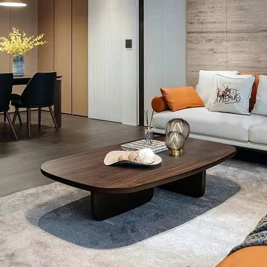 Nordic minimalist coffee table with rounded top and smooth sculptural wood base