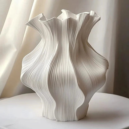 Textured ceramic wave vase with sculptural ripple shape and matte neutral finish