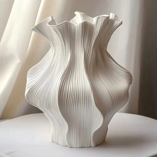 Textured ceramic wave vase with sculptural ripple shape and matte neutral finish