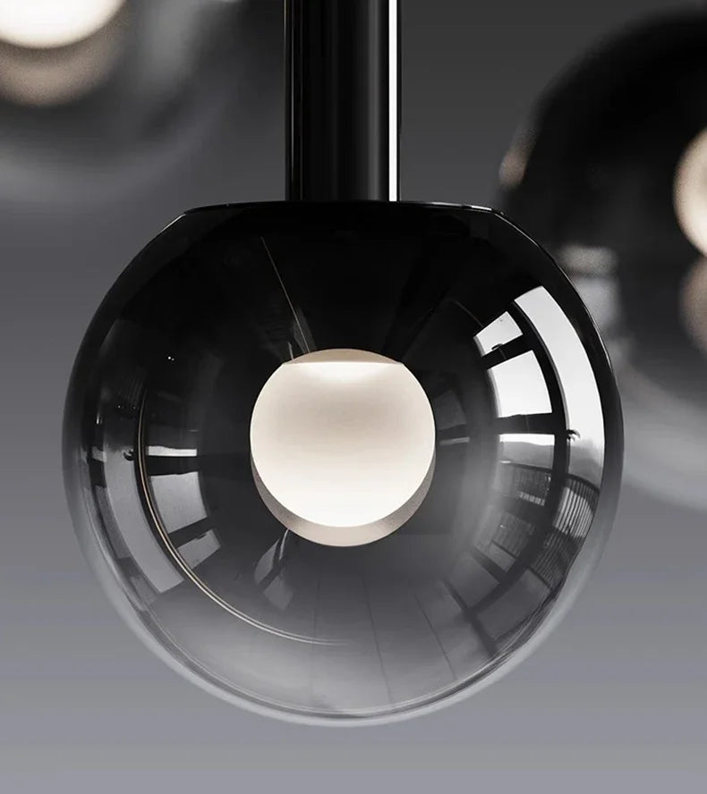 Close-up view of a modern spherical pendant light with a smoky glass shade and central glowing bulb, part of the Nordic Stair Chandelier — Living & Dining Room Pendant Ceiling Light collection.