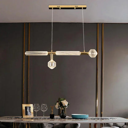 Elegant Nordic Luxury Art Glass Chandelier — High-End Pendant Lamp Home Décor in gold and glass with a modern design, hanging above a dining table with minimalist accents.