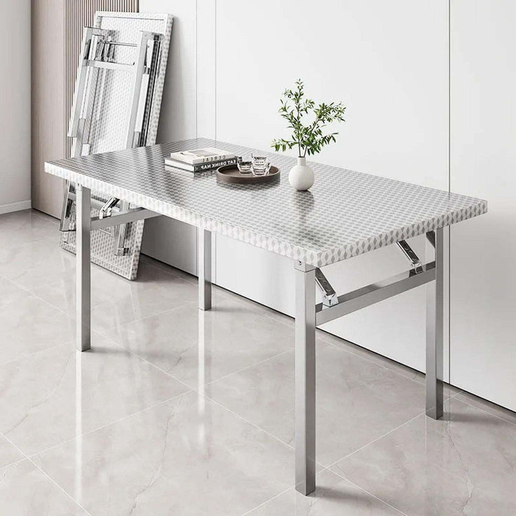 Foldable stainless steel buffet table with X-fold design set up for serving in dining room