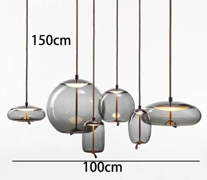 Modern LED Pendant Light — Chandelier for Living & Dining Room featuring six varying smoked glass pendants with brass accents, perfect for luxury home décor and statement lighting.