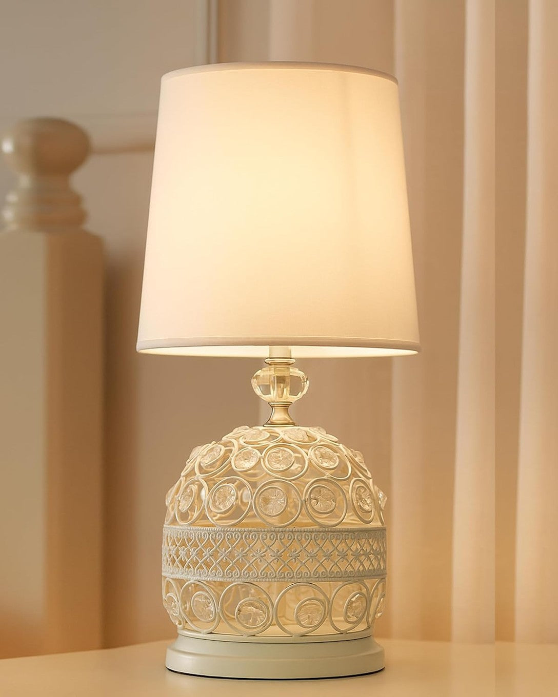 Small bedside table lamp with soft fabric shade and compact decorative base