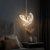 Modern rose gold LED pendant light with sleek metal finish in stylish bedroom setting