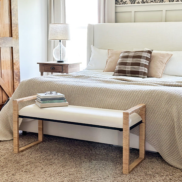 Wooden bench with woven rattan seat and light natural frame on a white background
